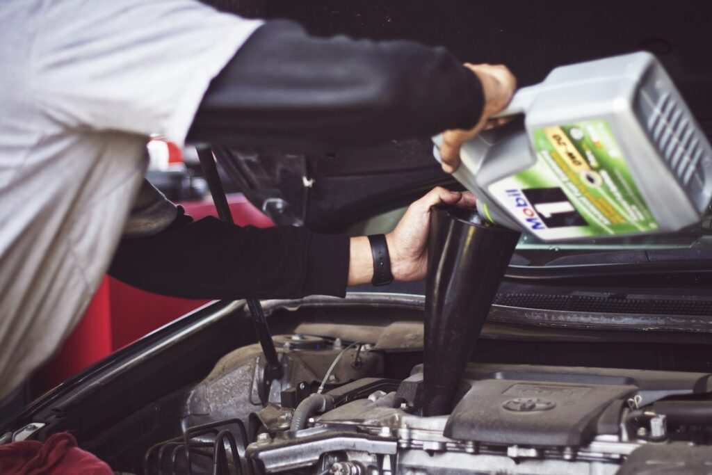 Mechanic working under the hood in a service bay